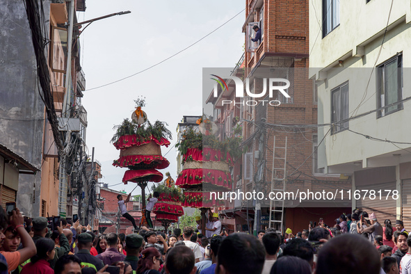 Nepalese Hindu devotees carry the chariot of Lord Satya Narayan during the Hadigaun Jatra festival in Kathmandu, Nepal, on October 18, 2024....