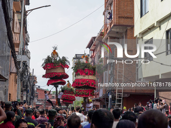 Nepalese Hindu devotees carry the chariot of Lord Satya Narayan during the Hadigaun Jatra festival in Kathmandu, Nepal, on October 18, 2024....