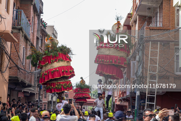 Nepalese Hindu devotees carry the chariot of Lord Satya Narayan during the Hadigaun Jatra festival in Kathmandu, Nepal, on October 18, 2024....