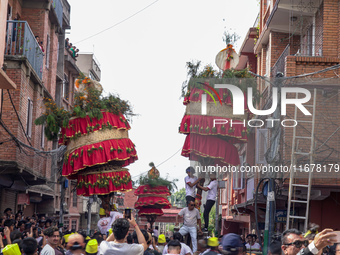 Nepalese Hindu devotees carry the chariot of Lord Satya Narayan during the Hadigaun Jatra festival in Kathmandu, Nepal, on October 18, 2024....