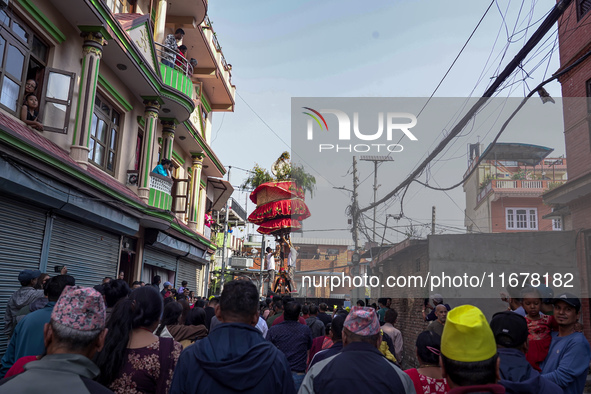 Nepalese Hindu devotees carry the chariot of Lord Satya Narayan during the Hadigaun Jatra festival in Kathmandu, Nepal, on October 18, 2024....