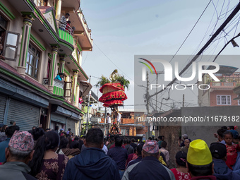 Nepalese Hindu devotees carry the chariot of Lord Satya Narayan during the Hadigaun Jatra festival in Kathmandu, Nepal, on October 18, 2024....