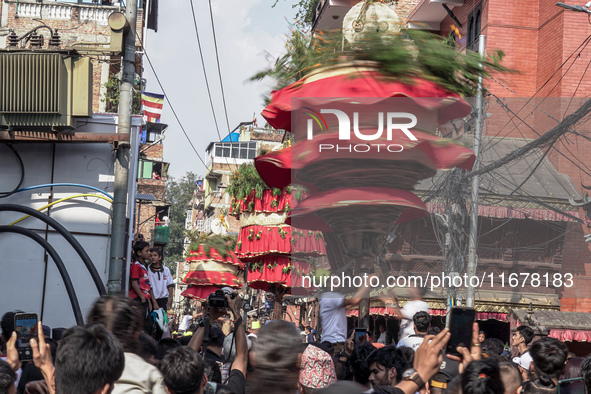 Nepalese Hindu devotees carry the chariot of Lord Satya Narayan during the Hadigaun Jatra festival in Kathmandu, Nepal, on October 18, 2024....