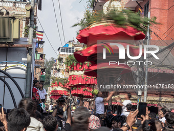 Nepalese Hindu devotees carry the chariot of Lord Satya Narayan during the Hadigaun Jatra festival in Kathmandu, Nepal, on October 18, 2024....