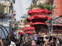 Nepalese Hindu devotees carry the chariot of Lord Satya Narayan during the Hadigaun Jatra festival in Kathmandu, Nepal, on October 18, 2024....