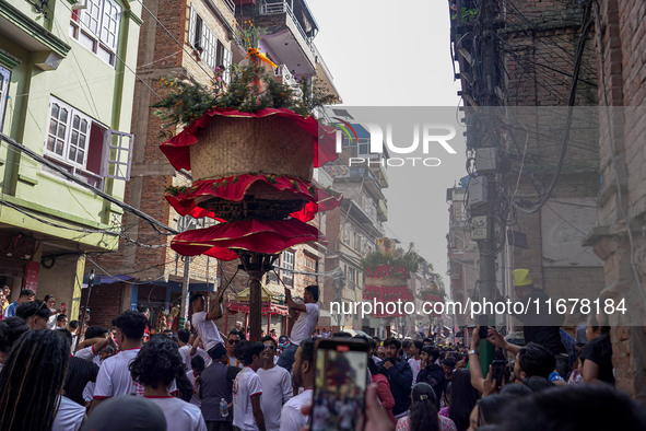 Nepalese Hindu devotees carry the chariot of Lord Satya Narayan during the Hadigaun Jatra festival in Kathmandu, Nepal, on October 18, 2024....