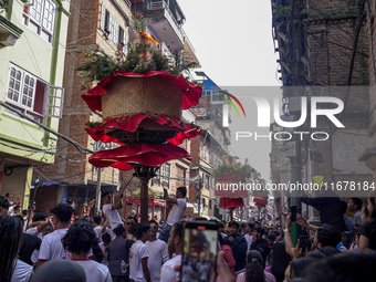 Nepalese Hindu devotees carry the chariot of Lord Satya Narayan during the Hadigaun Jatra festival in Kathmandu, Nepal, on October 18, 2024....