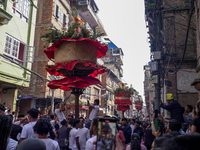 Nepalese Hindu devotees carry the chariot of Lord Satya Narayan during the Hadigaun Jatra festival in Kathmandu, Nepal, on October 18, 2024....