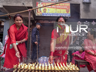 Nepalese Hindu devotees burn oil candles during the Hadigaun Jatra festival in Kathmandu, Nepal, on October 18, 2024. Every year, people acr...