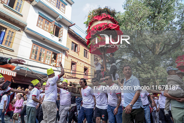 Nepalese Hindu devotees carry the chariot of Lord Satya Narayan during the Hadigaun Jatra festival in Kathmandu, Nepal, on October 18, 2024....