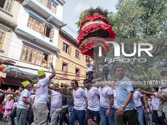 Nepalese Hindu devotees carry the chariot of Lord Satya Narayan during the Hadigaun Jatra festival in Kathmandu, Nepal, on October 18, 2024....