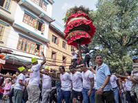 Nepalese Hindu devotees carry the chariot of Lord Satya Narayan during the Hadigaun Jatra festival in Kathmandu, Nepal, on October 18, 2024....