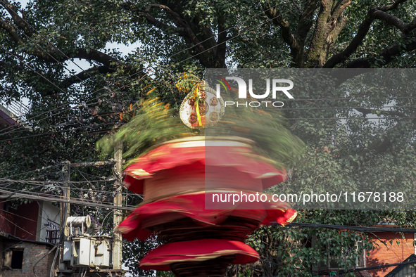 Nepalese Hindu devotees carry the chariot of Lord Satya Narayan during the Hadigaun Jatra festival in Kathmandu, Nepal, on October 18, 2024....