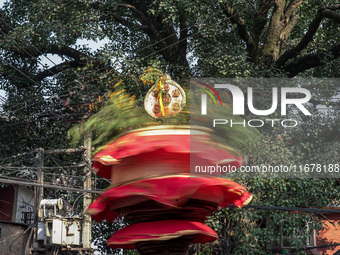 Nepalese Hindu devotees carry the chariot of Lord Satya Narayan during the Hadigaun Jatra festival in Kathmandu, Nepal, on October 18, 2024....