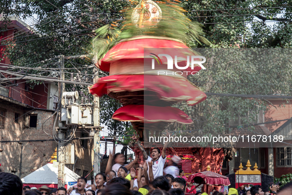 Nepalese Hindu devotees carry the chariot of Lord Satya Narayan during the Hadigaun Jatra festival in Kathmandu, Nepal, on October 18, 2024....