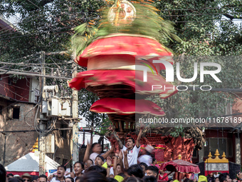 Nepalese Hindu devotees carry the chariot of Lord Satya Narayan during the Hadigaun Jatra festival in Kathmandu, Nepal, on October 18, 2024....