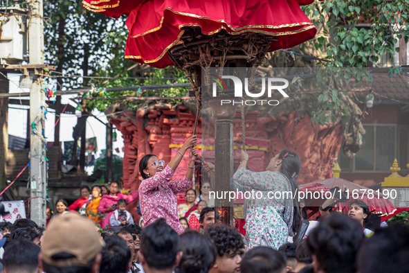 Nepalese Hindu devotees carry the chariot of Lord Satya Narayan during the Hadigaun Jatra festival in Kathmandu, Nepal, on October 18, 2024....