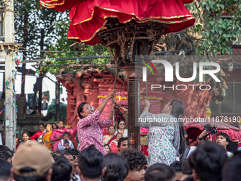 Nepalese Hindu devotees carry the chariot of Lord Satya Narayan during the Hadigaun Jatra festival in Kathmandu, Nepal, on October 18, 2024....