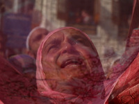 A Kashmiri Muslim devotee prays as a cleric displays a relic at the shrine of Sufi saint Sheikh Syed Abdul Qadir Jeelani, marking the last F...