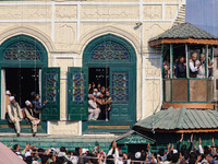 Kashmiri Muslim devotees pray as a cleric displays a relic at the shrine of Sufi saint Sheikh Syed Abdul Qadir Jeelani, marking the last Fri...