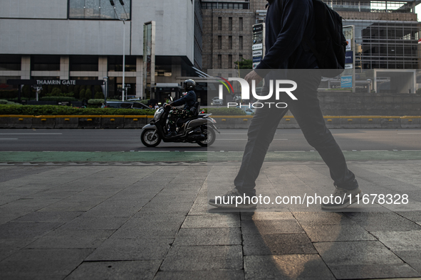 People walk on the pedestrian during rush hour ahead of the presidential inauguration in Jakarta, Indonesia, on October 18, 2024. Prabowo an...