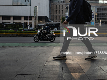 People walk on the pedestrian during rush hour ahead of the presidential inauguration in Jakarta, Indonesia, on October 18, 2024. Prabowo an...