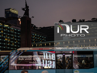 People are inside a bus during rush hour ahead of the presidential inauguration in Jakarta, Indonesia, on October 18, 2024. Prabowo and Gibr...