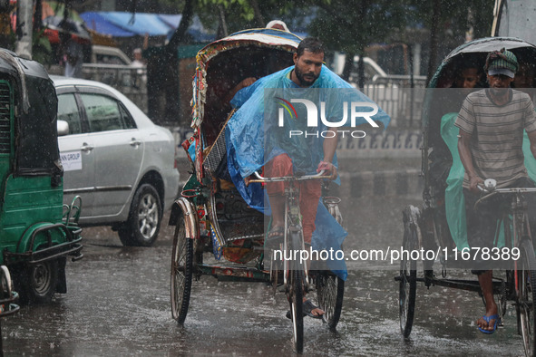 People suffer due to the rain in Dhaka, Bangladesh, on October 18, 2024. 