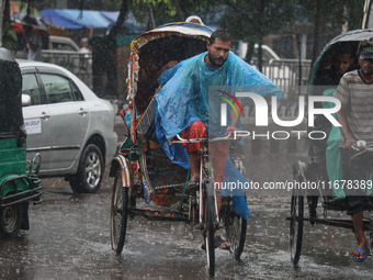 People suffer due to the rain in Dhaka, Bangladesh, on October 18, 2024. (