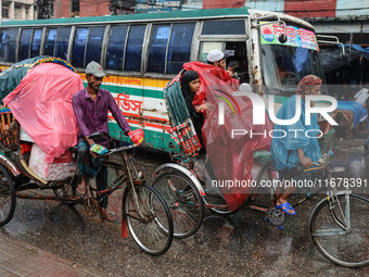 People suffer due to the rain in Dhaka, Bangladesh, on October 18, 2024. (