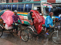 People suffer due to the rain in Dhaka, Bangladesh, on October 18, 2024. (