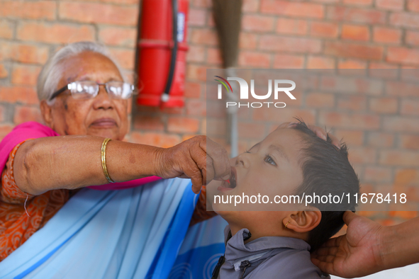 A Nepali child receives a ''Vitamin A'' capsule at an inoculation center in Kathmandu, Nepal, on October 18, 2024. 