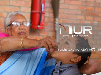 A Nepali child receives a ''Vitamin A'' capsule at an inoculation center in Kathmandu, Nepal, on October 18, 2024. (