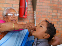 A Nepali child receives a ''Vitamin A'' capsule at an inoculation center in Kathmandu, Nepal, on October 18, 2024. (