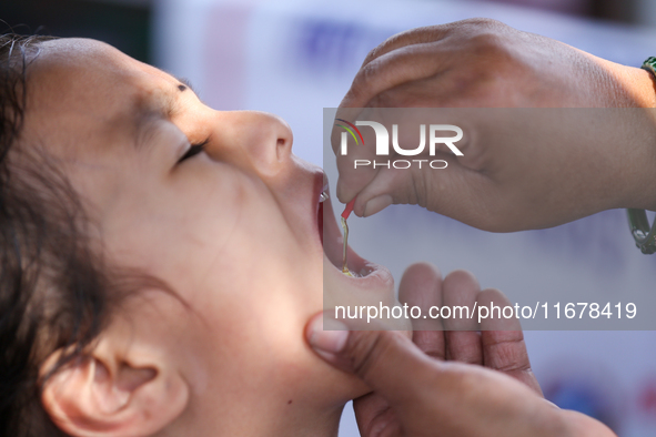 A Nepali child receives a ''Vitamin A'' capsule at an inoculation center in Kathmandu, Nepal, on October 18, 2024. 