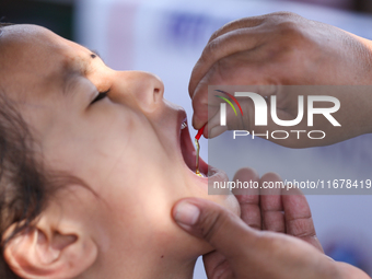 A Nepali child receives a ''Vitamin A'' capsule at an inoculation center in Kathmandu, Nepal, on October 18, 2024. (