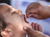 A Nepali child receives a ''Vitamin A'' capsule at an inoculation center in Kathmandu, Nepal, on October 18, 2024. (