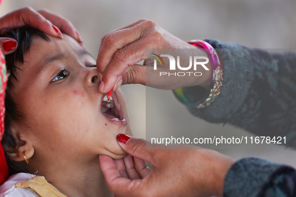 A Nepali child receives a ''Vitamin A'' capsule at an inoculation center in Kathmandu, Nepal, on October 18, 2024. 