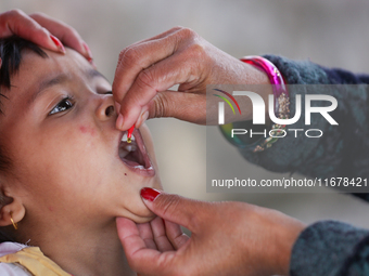 A Nepali child receives a ''Vitamin A'' capsule at an inoculation center in Kathmandu, Nepal, on October 18, 2024. (