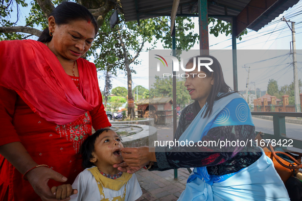 A Nepali child receives a ''Vitamin A'' capsule at an inoculation center in Kathmandu, Nepal, on October 18, 2024. 