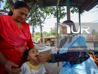 A Nepali child receives a ''Vitamin A'' capsule at an inoculation center in Kathmandu, Nepal, on October 18, 2024. (