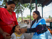 A Nepali child receives a ''Vitamin A'' capsule at an inoculation center in Kathmandu, Nepal, on October 18, 2024. (