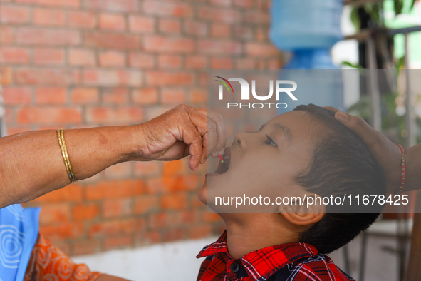 A Nepali child receives a ''Vitamin A'' capsule at an inoculation center in Kathmandu, Nepal, on October 18, 2024. 