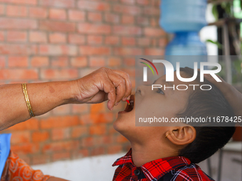 A Nepali child receives a ''Vitamin A'' capsule at an inoculation center in Kathmandu, Nepal, on October 18, 2024. (