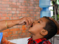 A Nepali child receives a ''Vitamin A'' capsule at an inoculation center in Kathmandu, Nepal, on October 18, 2024. (