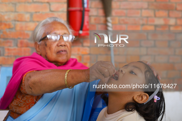 A Nepali child receives a ''Vitamin A'' capsule at an inoculation center in Kathmandu, Nepal, on October 18, 2024. 