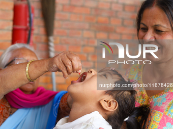 A Nepali child receives a ''Vitamin A'' capsule at an inoculation center in Kathmandu, Nepal, on October 18, 2024. (