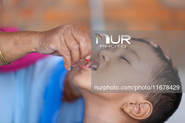 A Nepali child receives a ''Vitamin A'' capsule at an inoculation center in Kathmandu, Nepal, on October 18, 2024. 