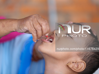 A Nepali child receives a ''Vitamin A'' capsule at an inoculation center in Kathmandu, Nepal, on October 18, 2024. (