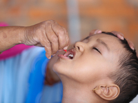 A Nepali child receives a ''Vitamin A'' capsule at an inoculation center in Kathmandu, Nepal, on October 18, 2024. (